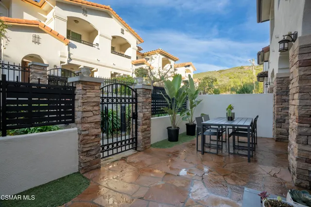 a view of a patio with a table and chairs
