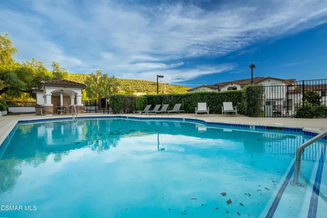 a swimming pool with outdoor seating and yard