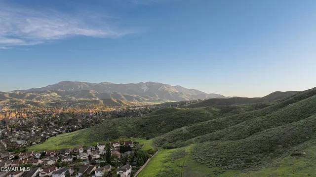 a view of a mountain range with lush green forest