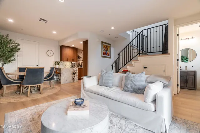 a living room with furniture or wooden floor and a chandelier