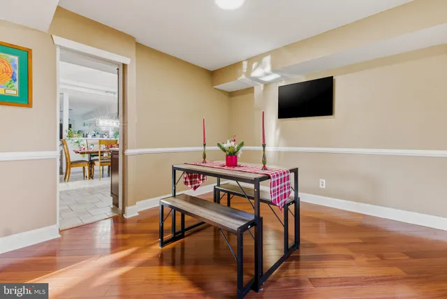 a view of a dining room with furniture and wooden floor