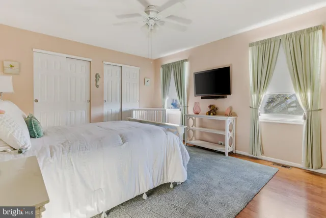 a spacious bedroom with a bed and a chandelier
