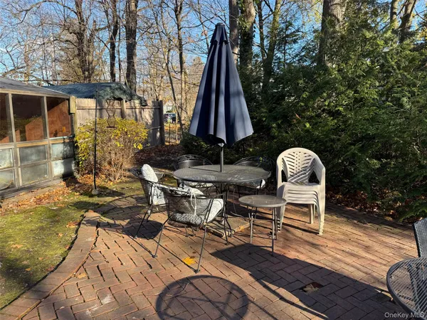 a view of a chairs and table on the patio