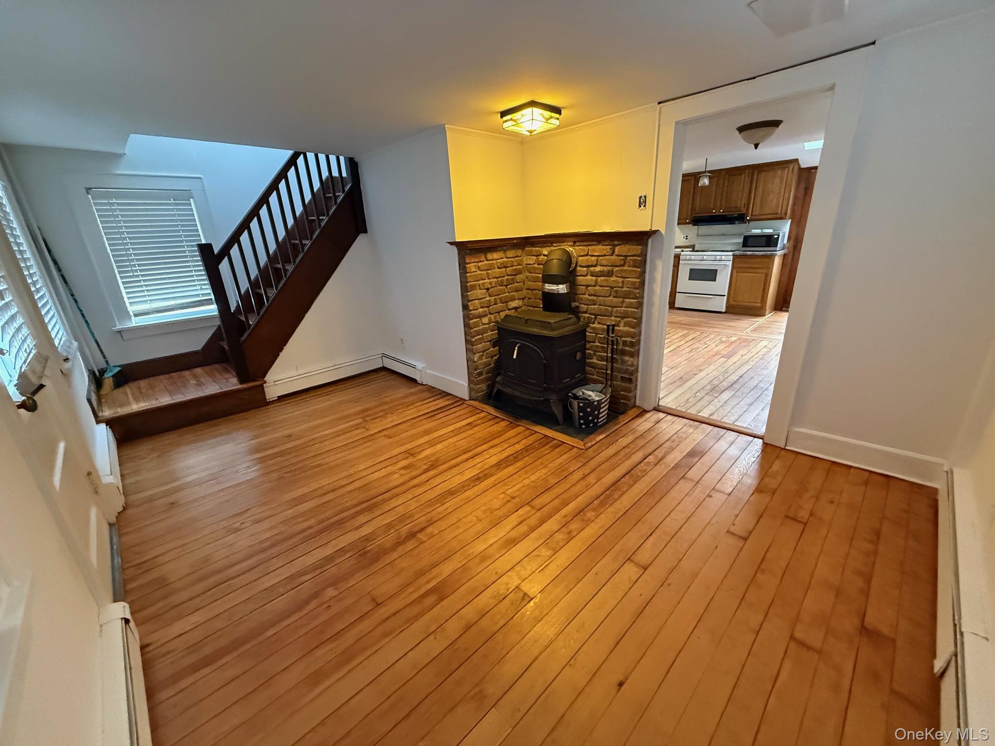 182 Maple Hill Road Huntington, NY 11743 - Photo 3 of 28 a view of a livingroom with wooden floor and stairs