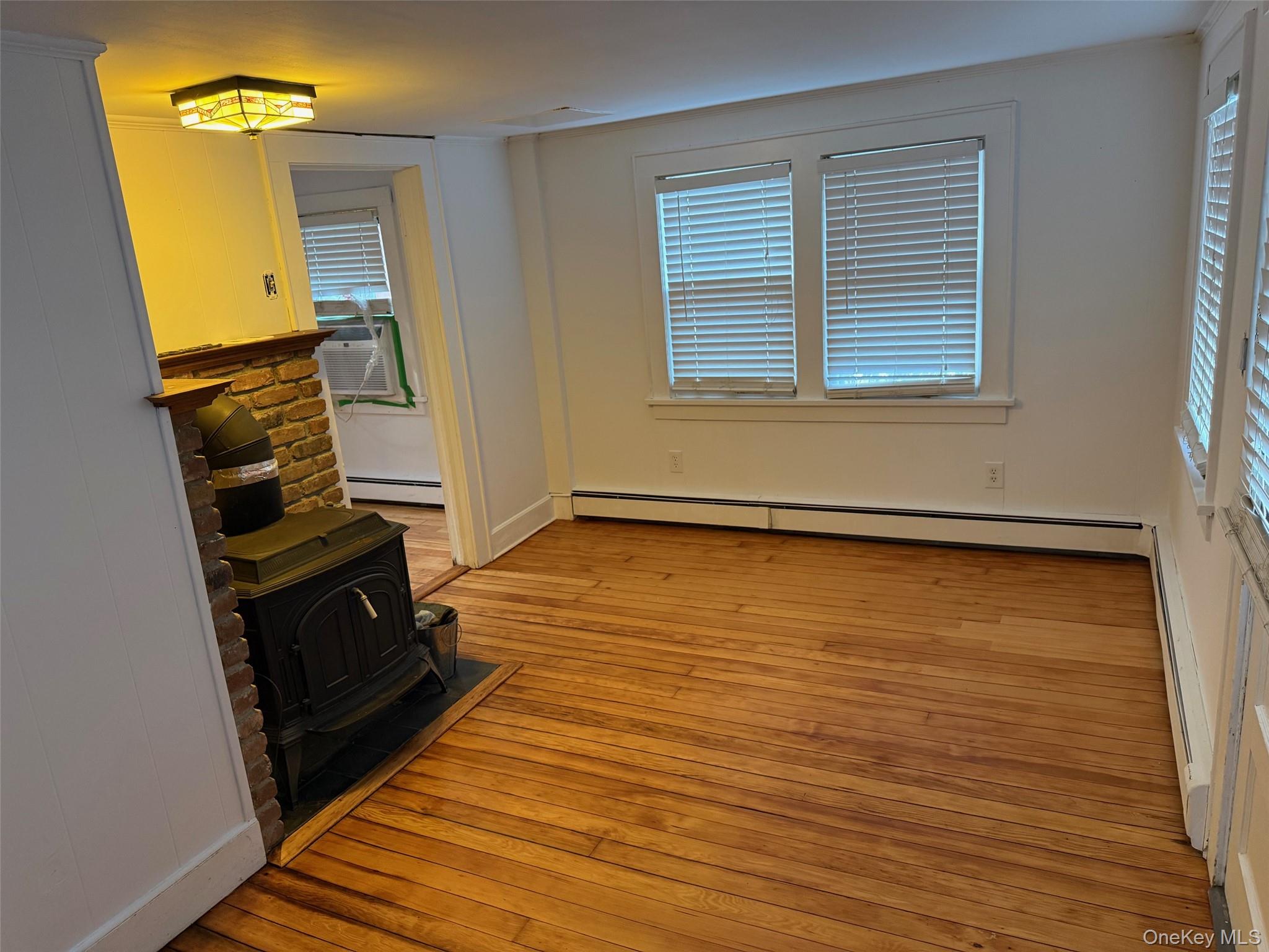 182 Maple Hill Road Huntington, NY 11743 - Photo 4 of 28 a view of an empty room with wooden floor and a window