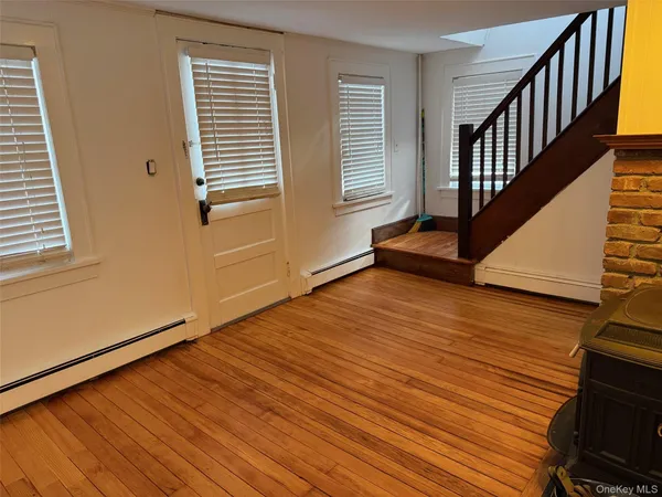 a view of an entryway with wooden floor