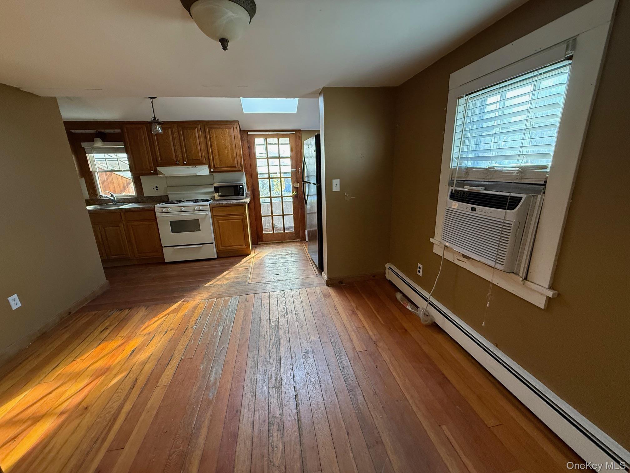 182 Maple Hill Road Huntington, NY 11743 - Photo 6 of 24 a kitchen with sink cabinets and wooden floor