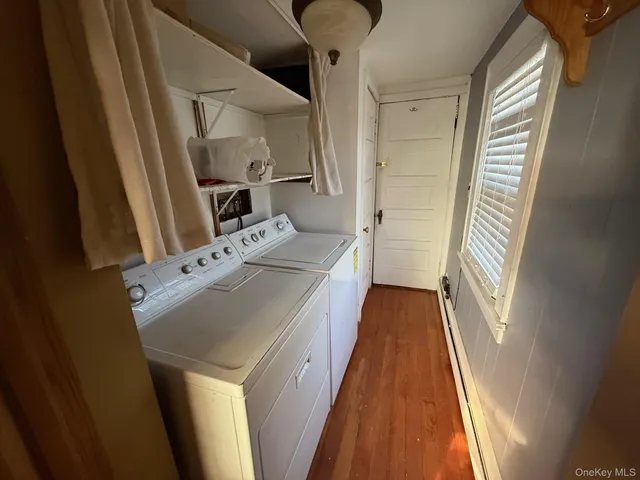a view of washer and dryer with wooden floor
