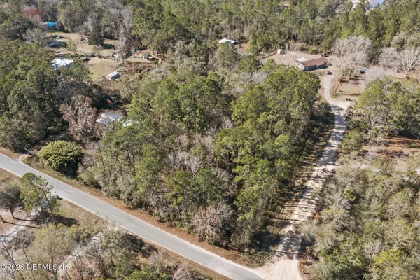 a view of a yard with wooden fence