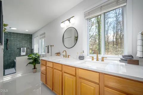 a bathroom with a double vanity sink and a large mirror