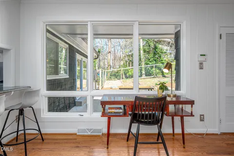 a view of a dining room with furniture window and wooden floor