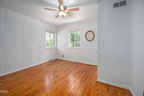 a view of a room with wooden floor and window