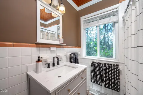 a bathroom with a sink and a window