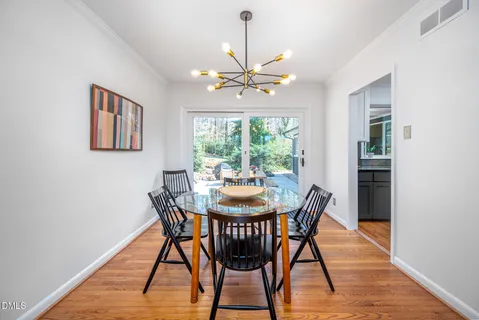 a dining room with furniture a rug and a chandelier