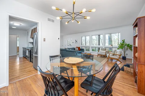 a view of a dining room with furniture window and wooden floor