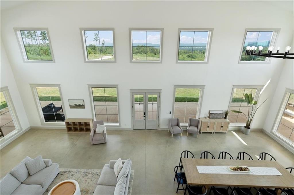 664 Wiggins Road Lyerly, GA 30730 - Photo 18 of 69 a living room with couches and kitchen view with wooden floor