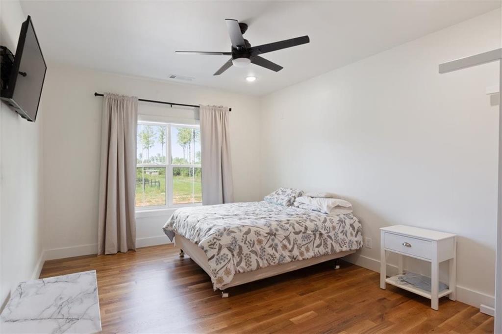 664 Wiggins Road Lyerly, GA 30730 - Photo 30 of 69 a bedroom with a bed a flat screen tv and a window