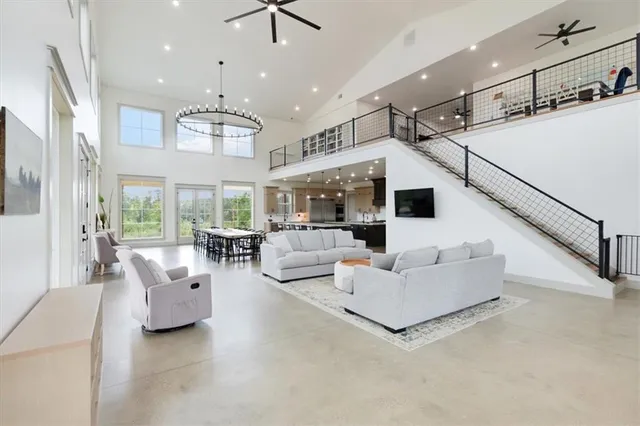 a living room with furniture and a chandelier