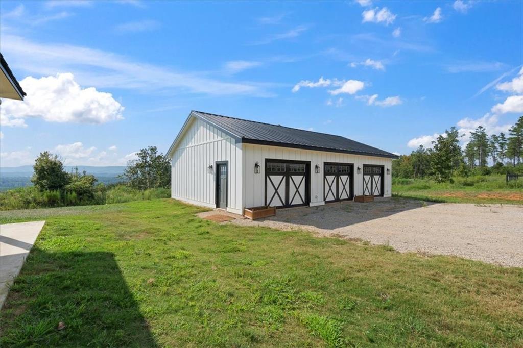 664 Wiggins Road Lyerly, GA 30730 - Photo 48 of 69 a view of a house with yard and garage