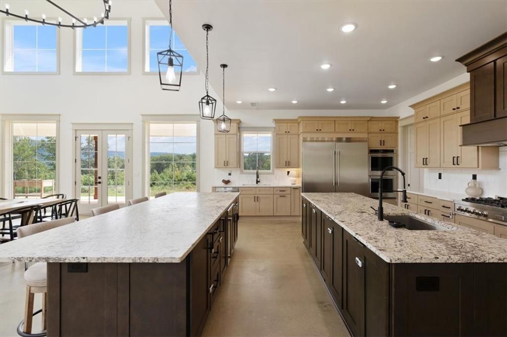 664 Wiggins Road Lyerly, GA 30730 - Photo 10 of 69 a kitchen with granite countertop kitchen island a sink a stove and a large window