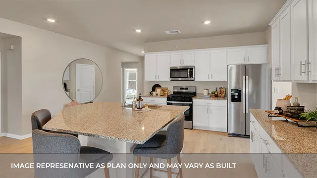 a kitchen with sink refrigerator and stove