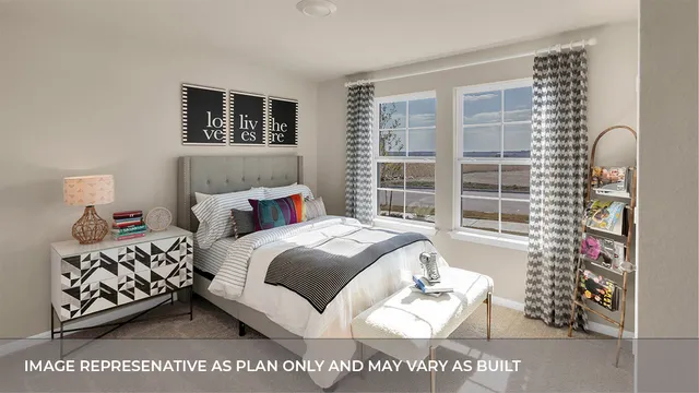 a spacious bedroom with a bed next to a window