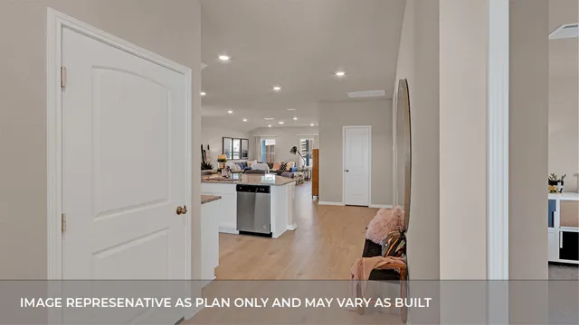 a open kitchen with white cabinets and stainless steel appliances