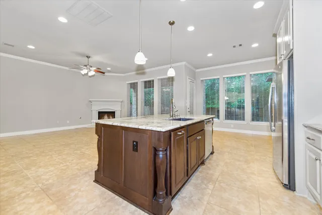 a large kitchen with a large counter top and stainless steel appliances