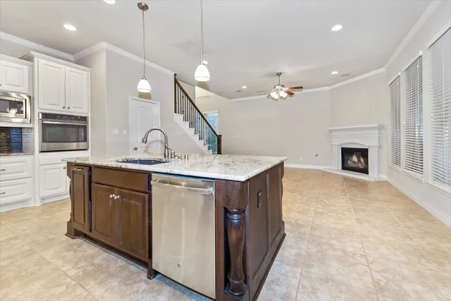 a kitchen with kitchen island a sink stainless steel appliances and cabinets