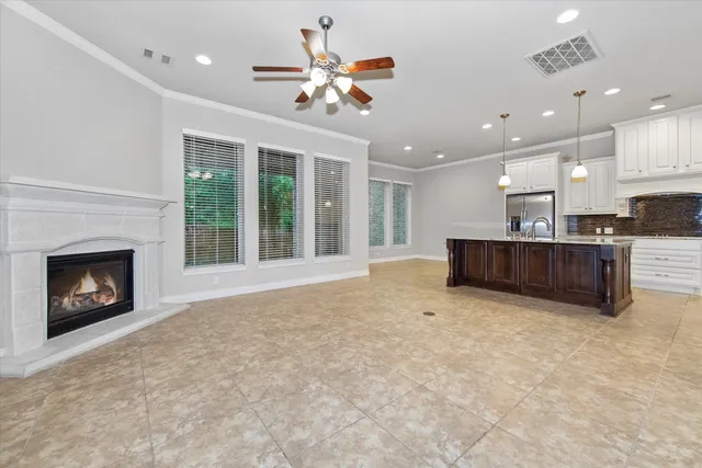 a view of kitchen with granite countertop cabinets and fireplace