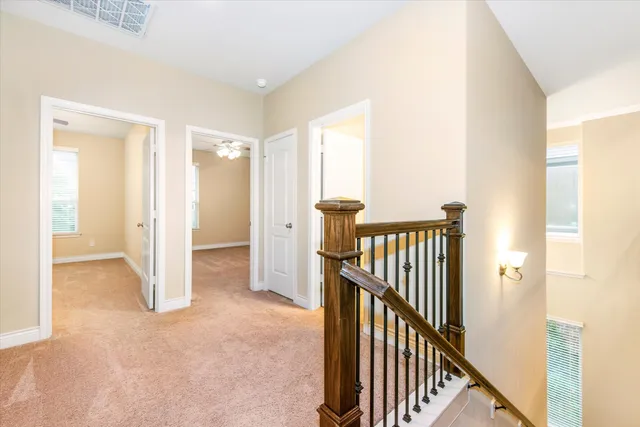 a view of a hallway with wooden floor and entryway