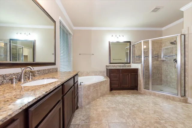 a spacious bathroom with a granite countertop sink a toilet and shower