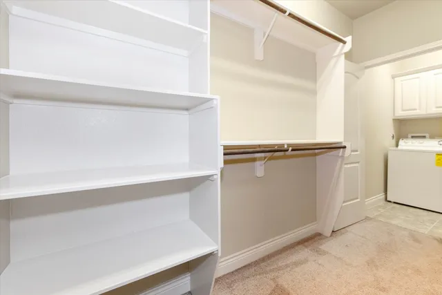 a view of walk in closet with empty racks