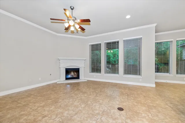 a view of an empty room with a fireplace and a window