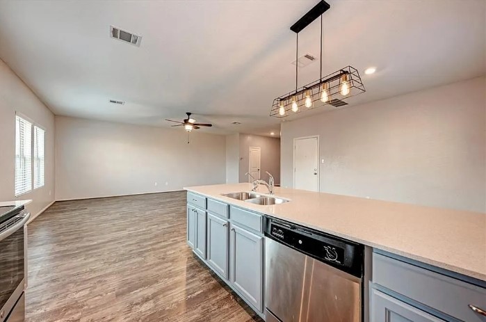 817 Circle Way, Unit 7I Jarrell, TX 76537 - Photo 11 of 33 Kitchen with stainless steel appliances, gray cabinets, decorative light fixtures, light stone countertops, and recessed lighting