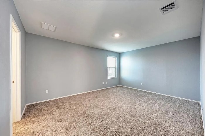 817 Circle Way, Unit 7I Jarrell, TX 76537 - Photo 18 of 33 Empty room with light colored carpet and baseboards