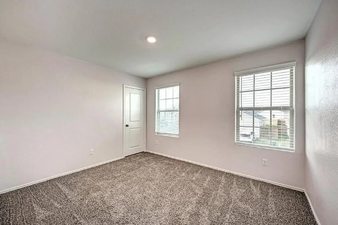 817 Circle Way, Unit 7I Jarrell, TX 76537 - Photo 26 of 33 Carpeted spare room with baseboards