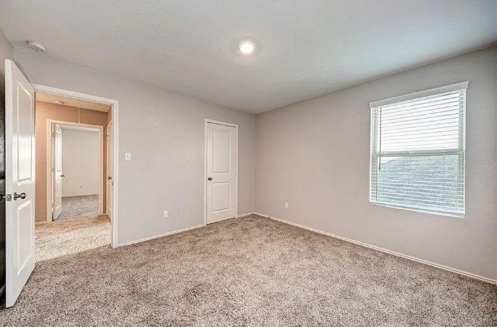 817 Circle Way, Unit 7I Jarrell, TX 76537 - Photo 27 of 33 Unfurnished bedroom with light carpet and baseboards