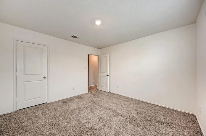 817 Circle Way, Unit 7I Jarrell, TX 76537 - Photo 28 of 33 Unfurnished bedroom featuring carpet and baseboards