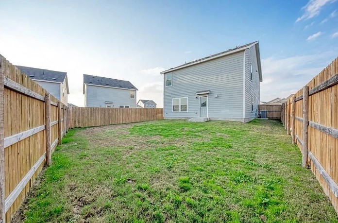 817 Circle Way, Unit 7I Jarrell, TX 76537 - Photo 33 of 33 Rear view of house featuring a fenced backyard