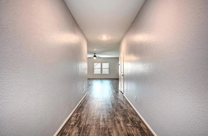 817 Circle Way, Unit 7I Jarrell, TX 76537 - Photo 5 of 33 Hall with a textured wall and dark wood-type flooring