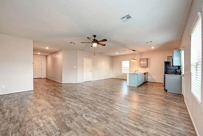 817 Circle Way, Unit 7I Jarrell, TX 76537 - Photo 6 of 33 Unfurnished living room with dark wood finished floors, ceiling fan, and recessed lighting