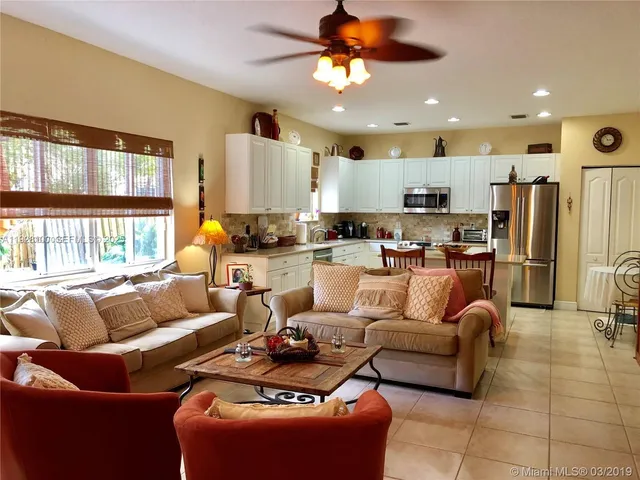 a living room with furniture kitchen and a view of kitchen