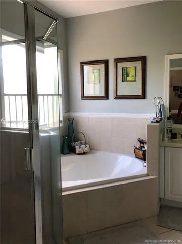 a view of a hallway with wooden floor and closet