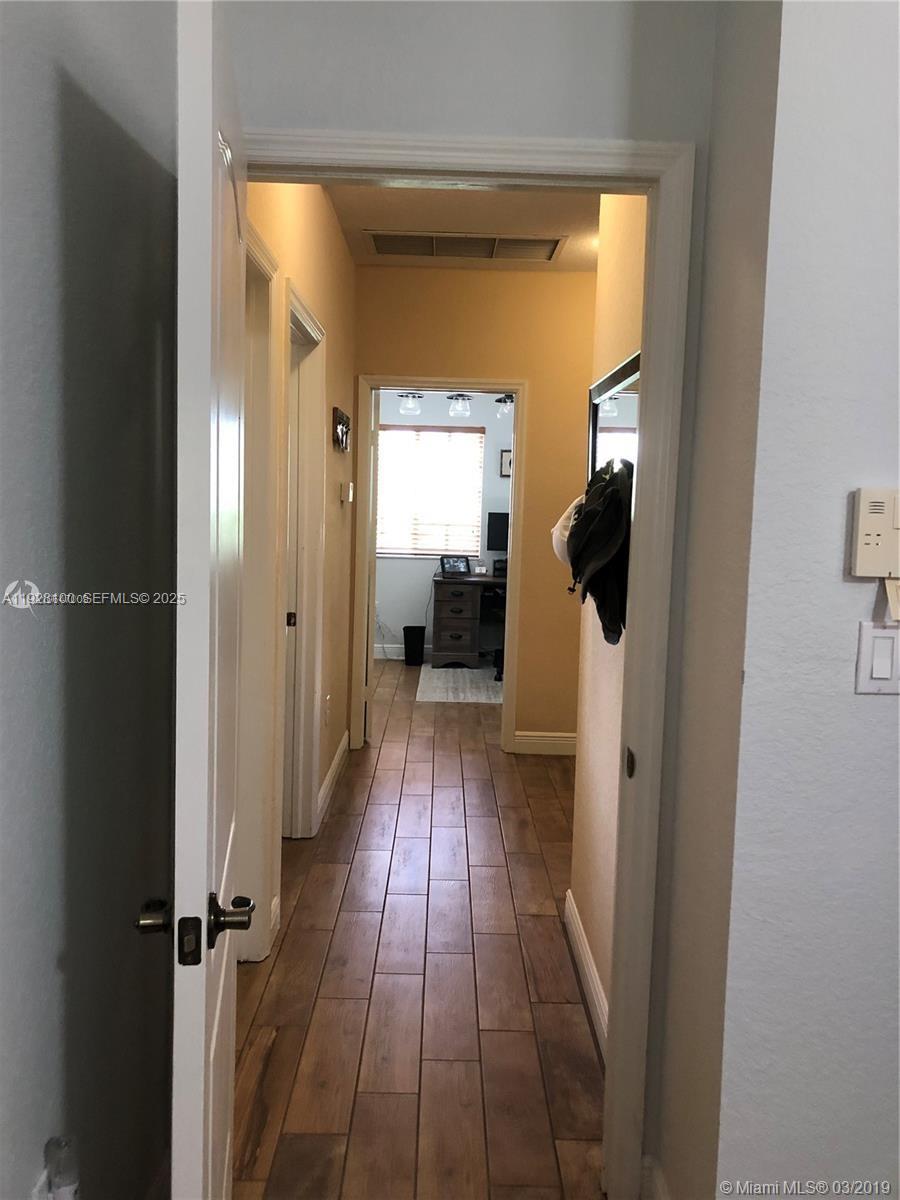 867 Southwest 155th Court Miami, FL 33194 - Photo 26 of 31 a view of a hallway with wooden floor and closet