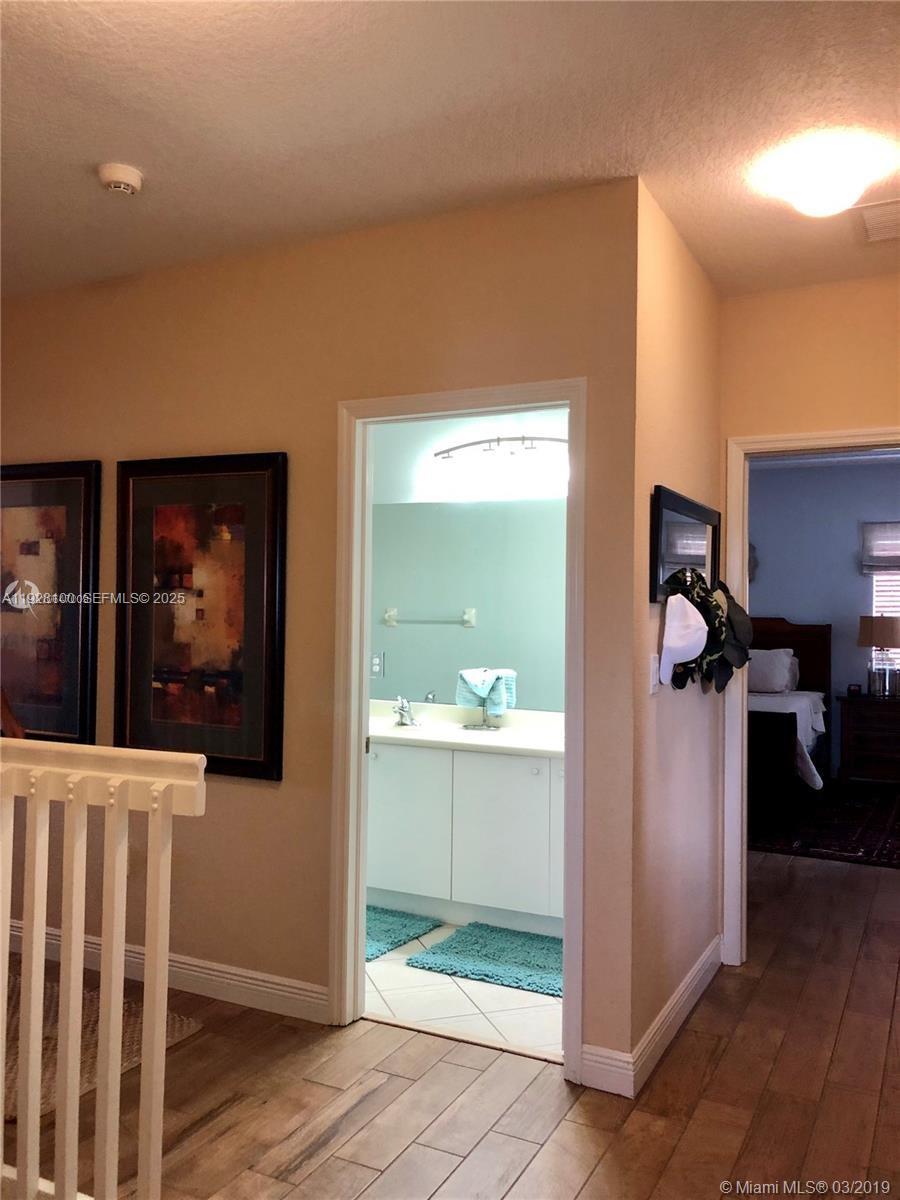 867 Southwest 155th Court Miami, FL 33194 - Photo 28 of 31 a view of a hallway with wooden floor and windows