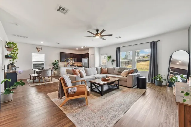 a living room with furniture and wooden floor