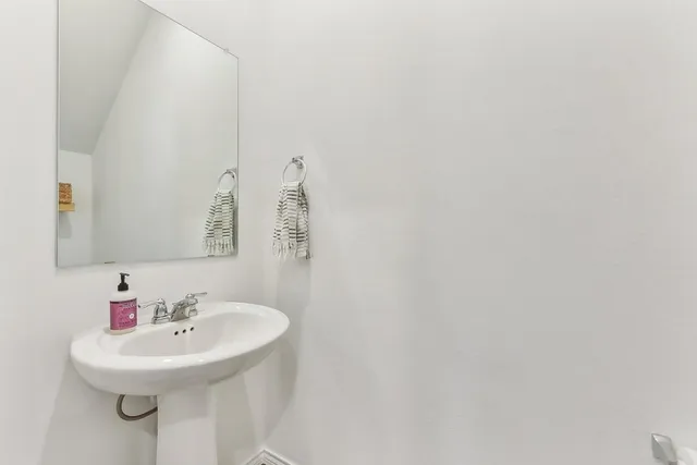 a bathroom with a sink a mirror and a toilet