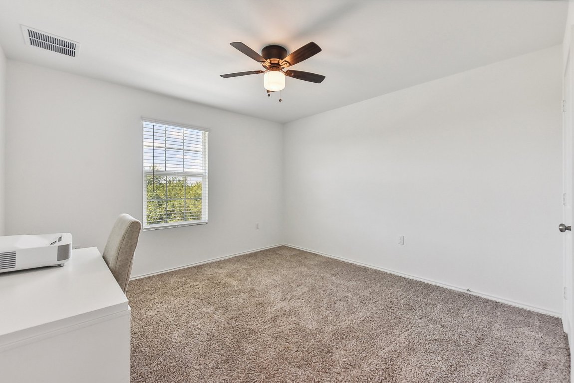 5908 Eden Drive Austin, TX 78747 - Photo 16 of 31 an empty room with a window and a ceiling fan