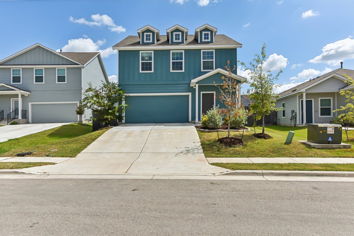 5908 Eden Drive Austin, TX 78747 - Photo 2 of 31 a front view of a house with a yard and potted plants